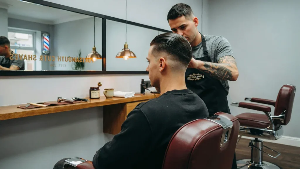 Slicked back undercut haircut finished in a modern Portsmouth barbershop